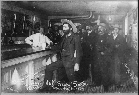 Jefferson Randolph "Soapy" Smith stands at a bar in Skagway, Alaska during the Gold Rush of 1898